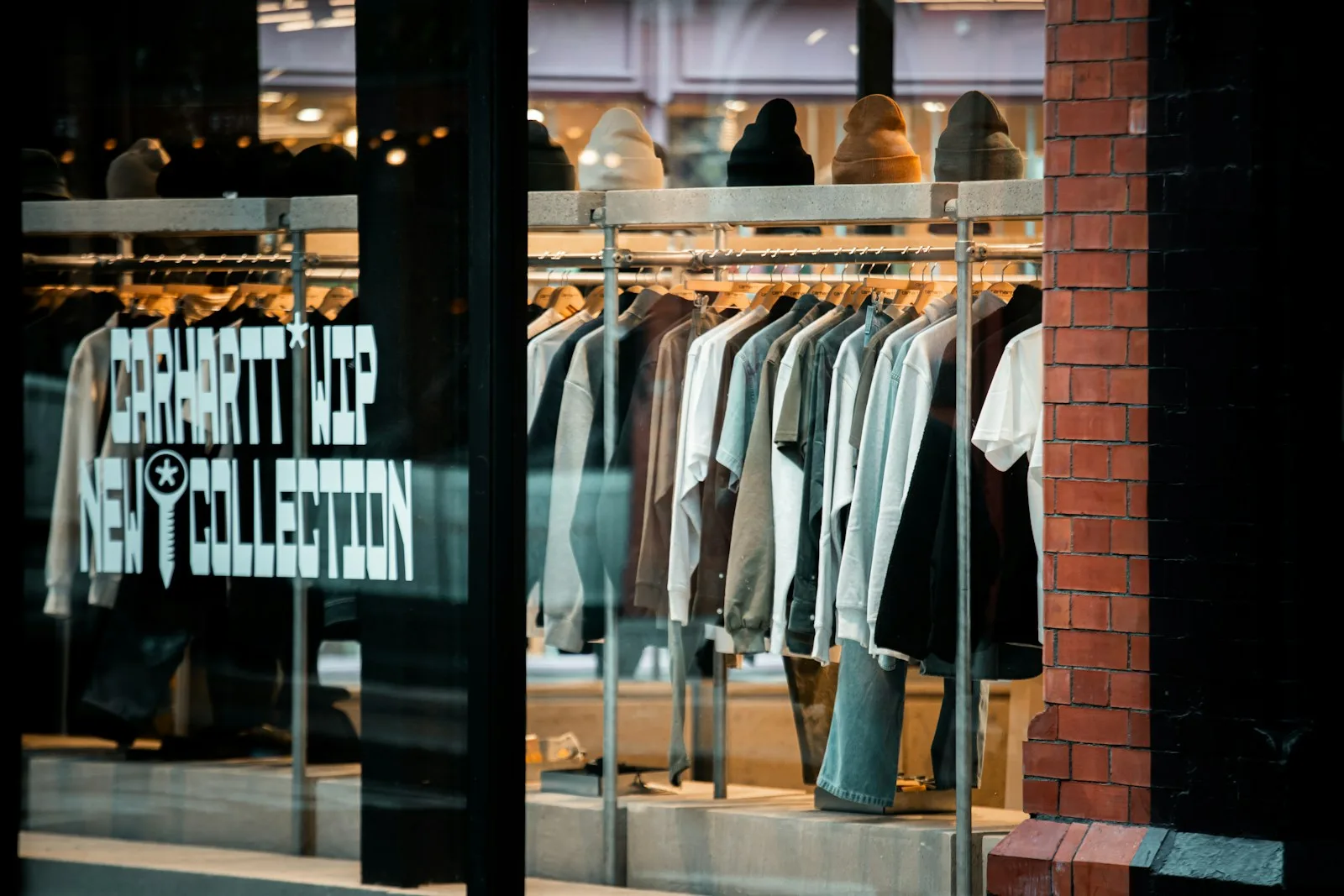 Clothing on racks in a boutique window